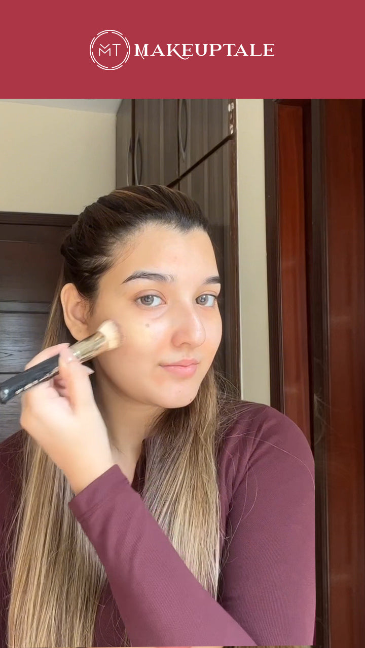 Person applying makeuptale makeup with a brush in a home setting. this is before Makeuptale products applying image